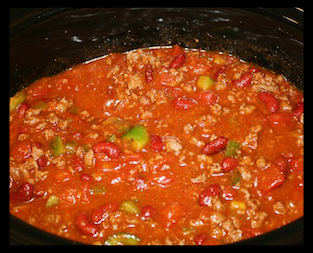    Slow Cooker Chili  INGREDIENTS:  1.	1 lb. ground beef 2.	2 cups diced tomatoes 3.	2 oz. tomato paste 4.	1 cup dark red kidney beans 5.	1 onion, chopped 6.	½ cup red and green peppers, chopped 7.	1 envelope chili seasonings 8.	1 clove garlic, minced 9.	1 tsp. chili powder 10.	Hot sauce to taste 11.	1 oz. dark chocolate  DIRECTIONS:  1.	Add all ingredients except beef to slow cooker 2.	(Get all the tomato paste out of can by adding water to the can) 3.	Break beef into small pieces and add to cooker 4.	Stir well  5.	Cook 6-8 hours on low heat  Serve with shredded cheddar and sour cream  